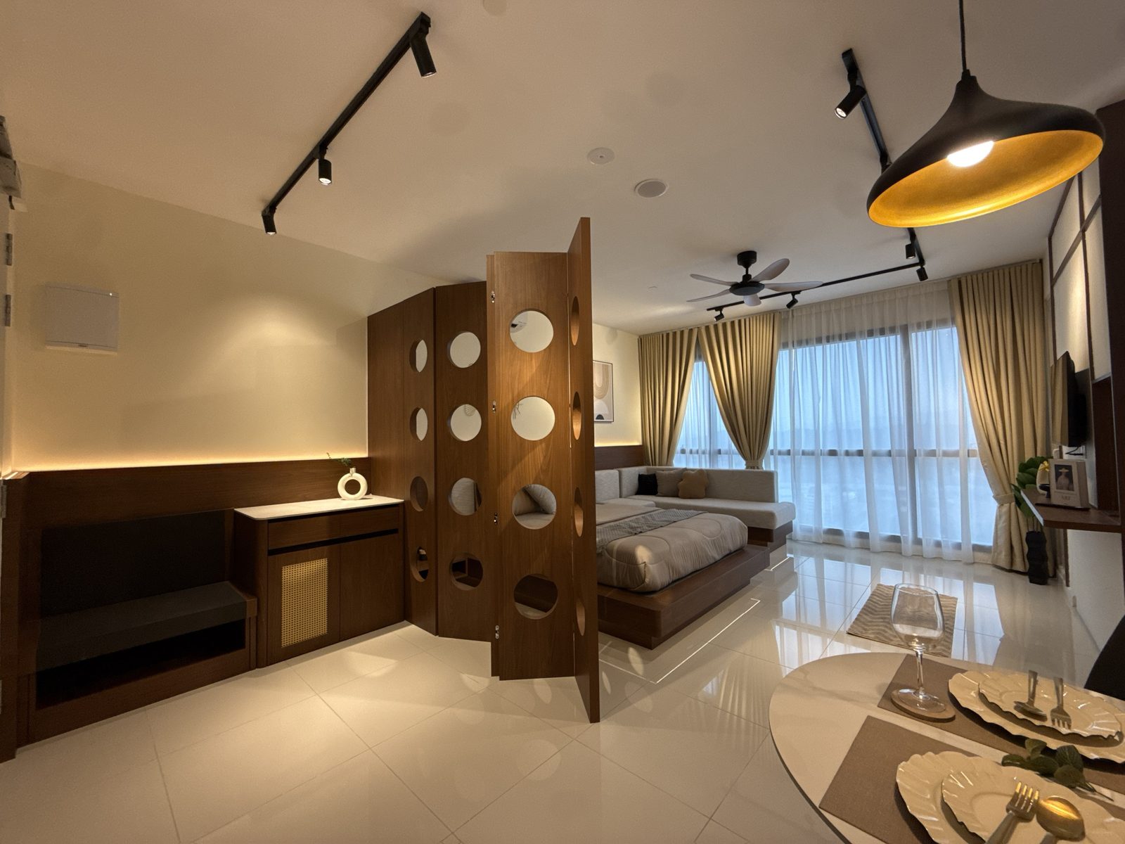 Edelweiss studio entrance with wooden circle-cut room divider and dining area
