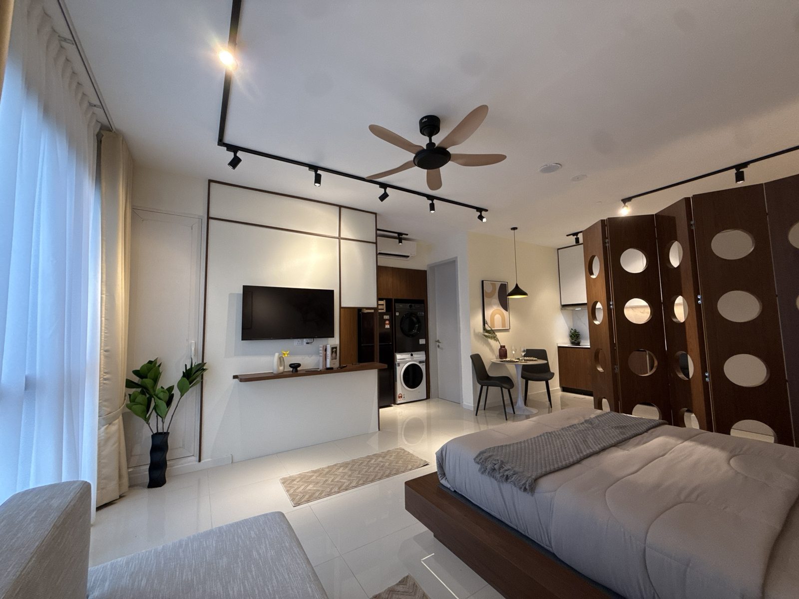 Edelweiss studio TV wall, built-in laundry and dining corner